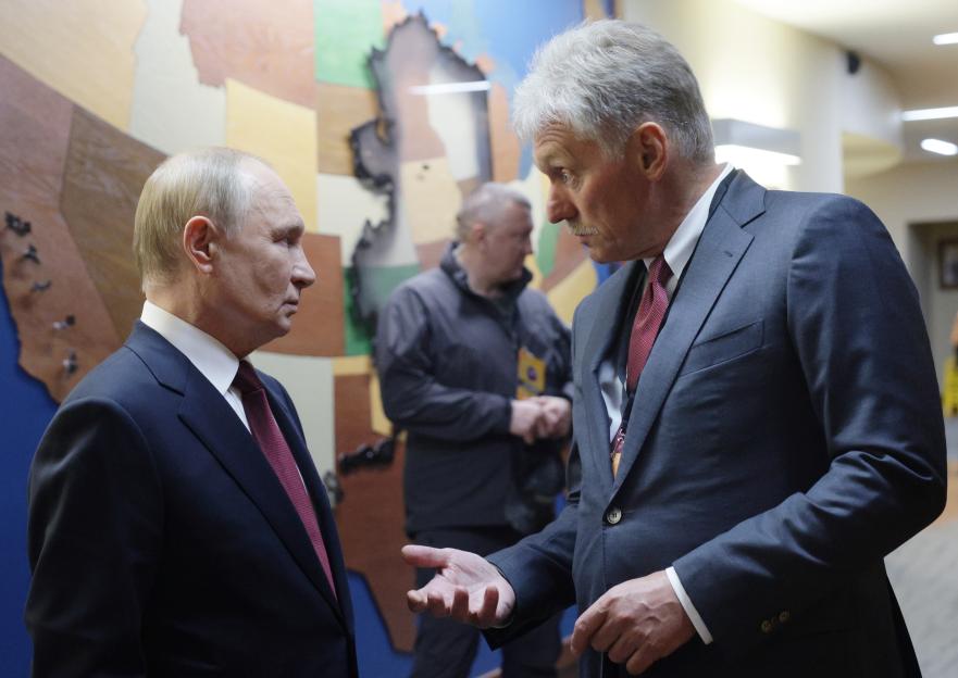 Russian President Vladimir Putin speaks with Kremlin spokesman Dmitry Peskov.