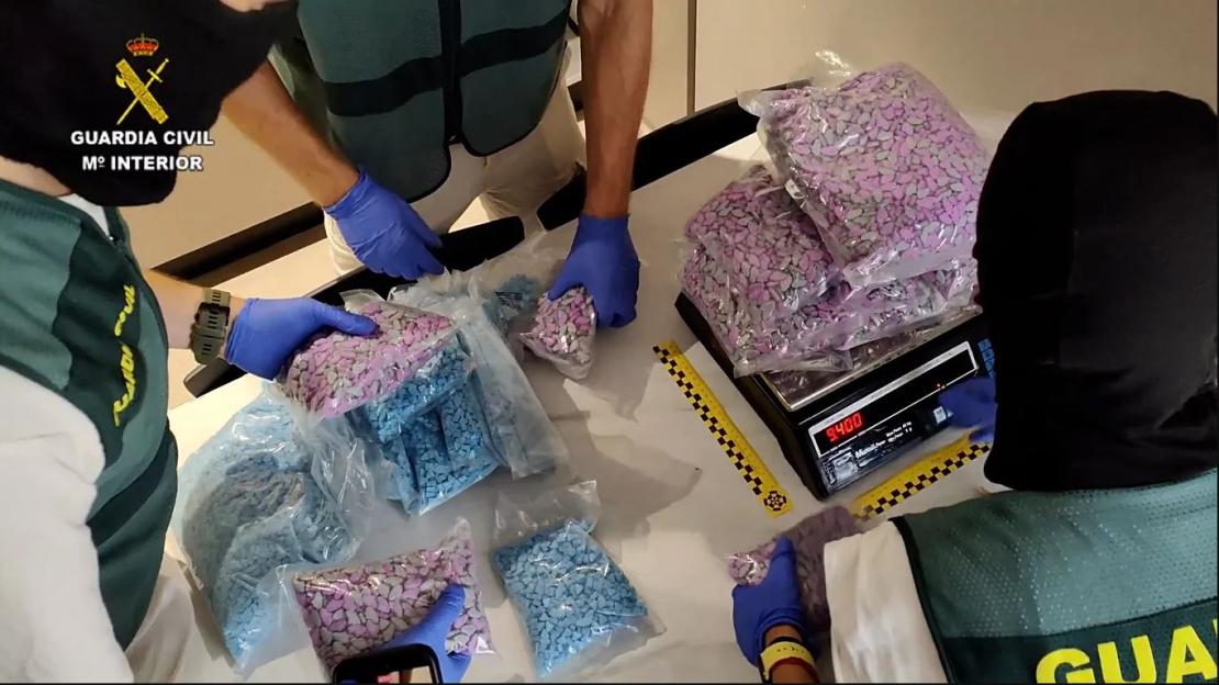 Spanish police seizing bags of drugs.