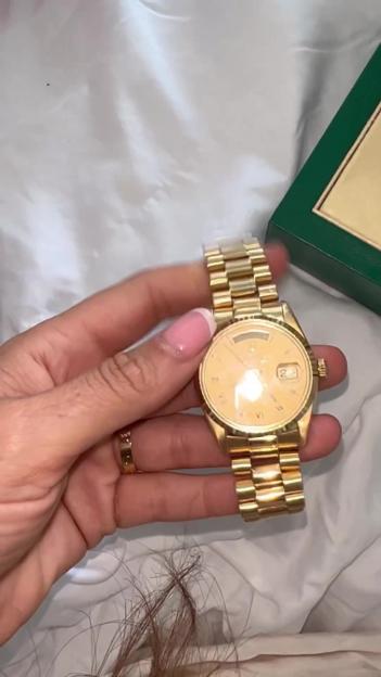 A gold Rolex watch.