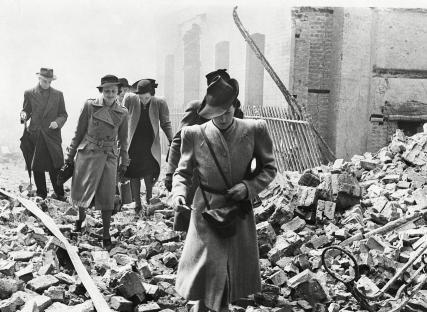 London workers navigating debris after a World War II air raid.