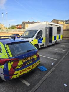 Police car and van at a crime scene.