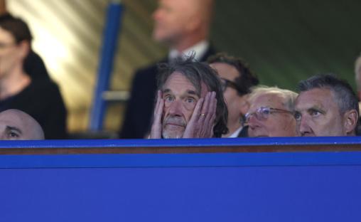 Sir Jim Ratcliffe looking disappointed at a sporting event.