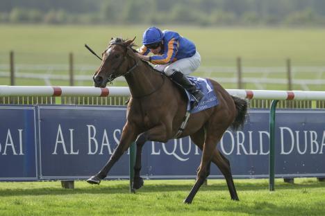 Ryan Moore riding Bubbling to victory in a horse race.