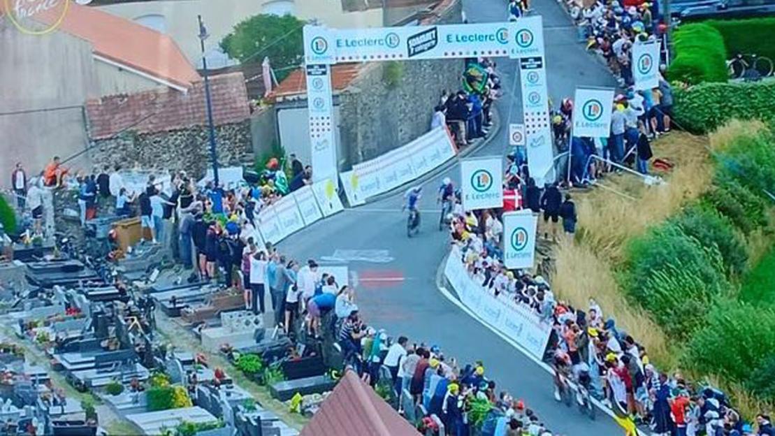 Tour de France fans slammed as ‘disrespectful’ after spectators spotted climbing on GRAVES to catch glimpse of the race