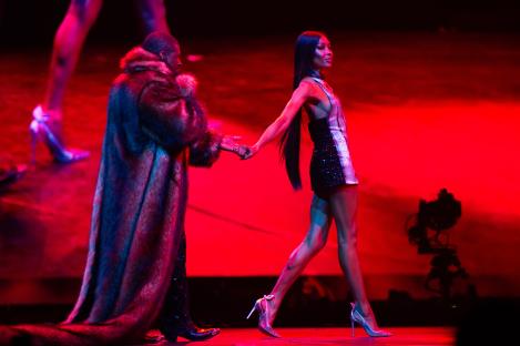 Usher and Naomi Campbell performing on stage.