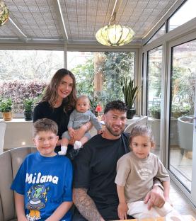 Family portrait in a sunroom.