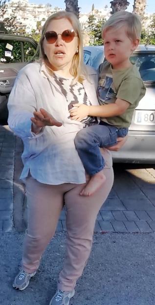 Angela Nikolenko, 58, a Russian national, holding a toddler.