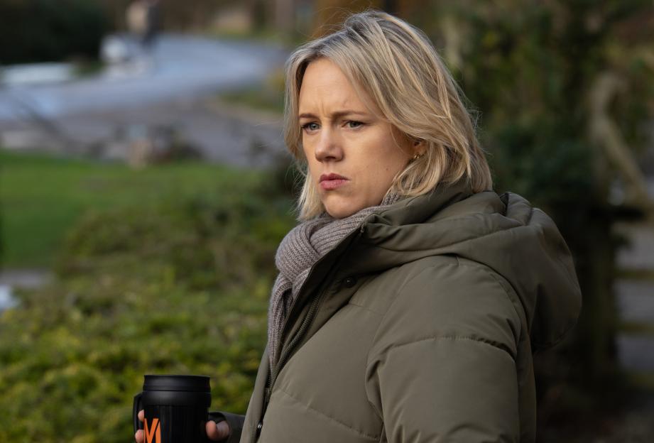 Steph from Emmerdale looking pensive, holding a travel mug.