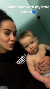 Woman holding baby at swim time.