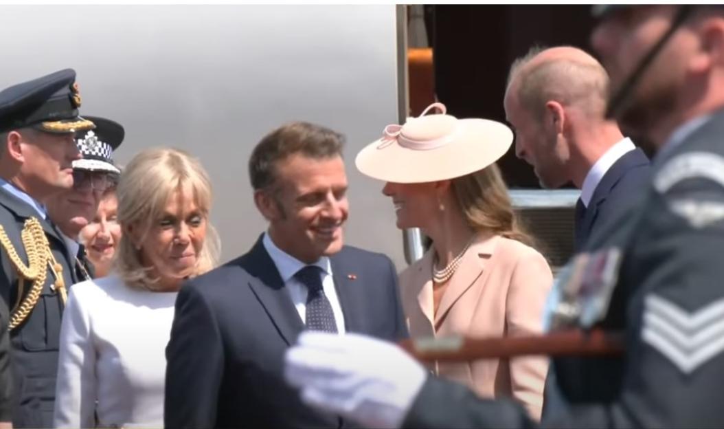 Brigitte and Emmanuel Macron greeting someone.