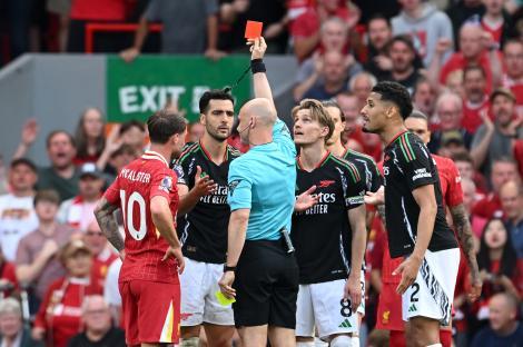 Mikel Merino of Arsenal receiving a red card in a soccer match.