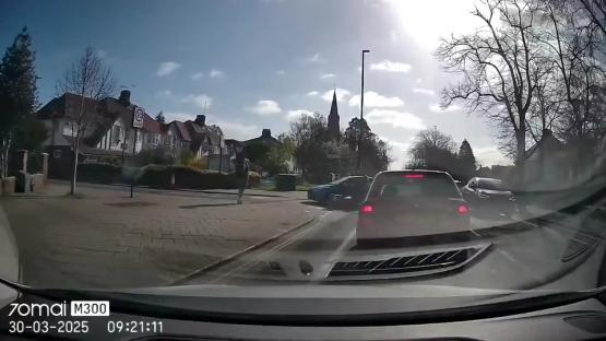 Dashcam footage of a moped colliding with a car.