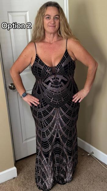 A woman in a black and gold sequined dress with thin straps and a plunging neckline.