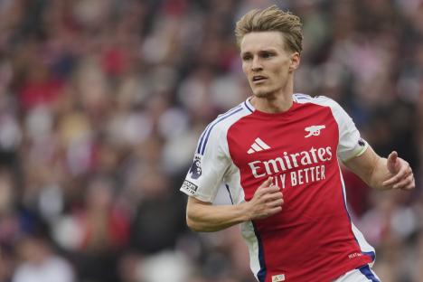 Martin Odegaard of Arsenal running during a soccer match.
