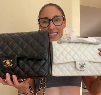 Woman comparing a black and a white Chanel handbag.