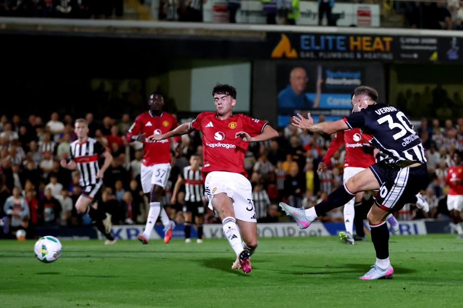 Charles Vernam scoring a goal during a soccer match.