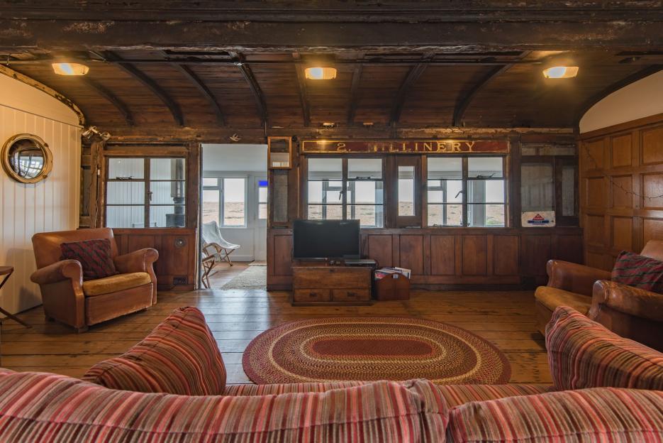 Interior view of a Victorian train carriage converted into a living space.