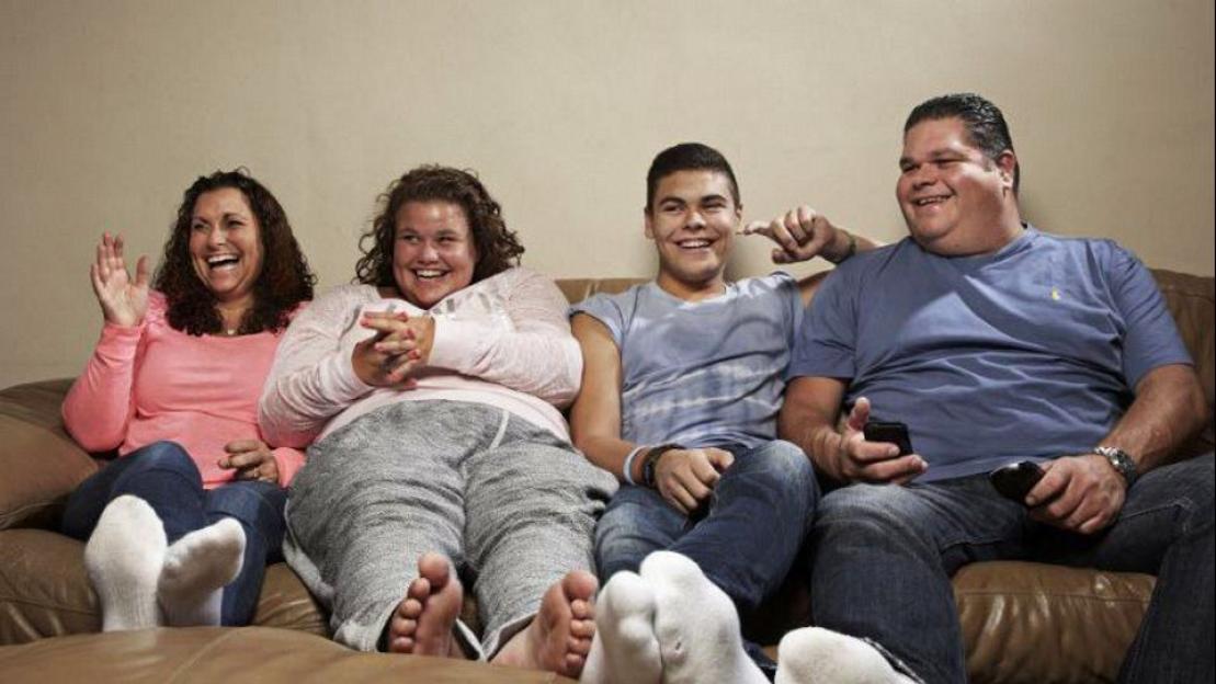 The Tapper family from Gogglebox laughing on a sofa.