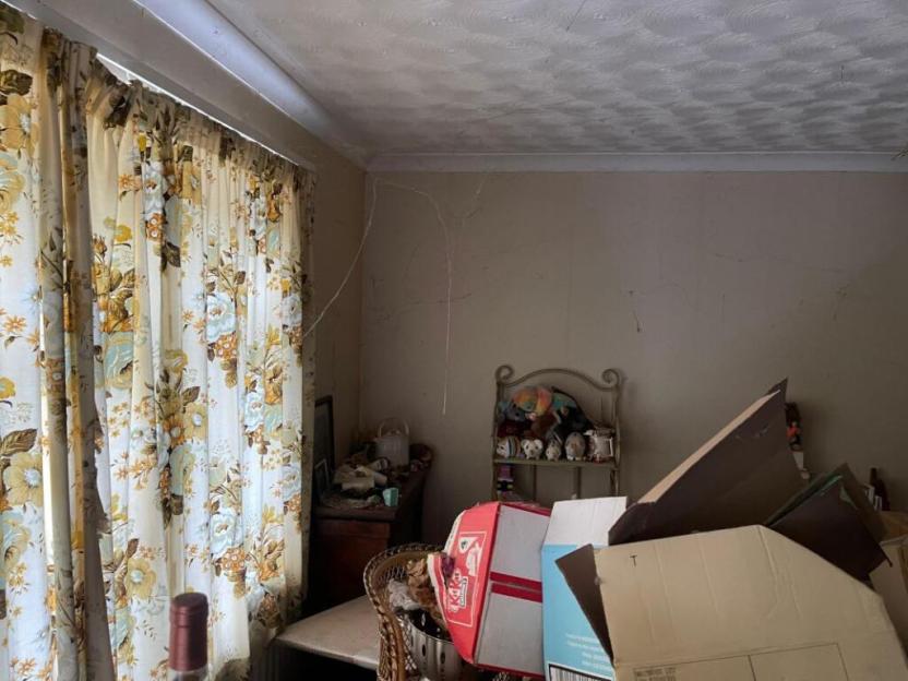 Interior of a cluttered room in a house for sale.