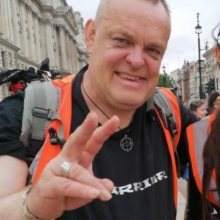 Photo of David Mann, a Just Stop Oil protestor, giving a peace sign.