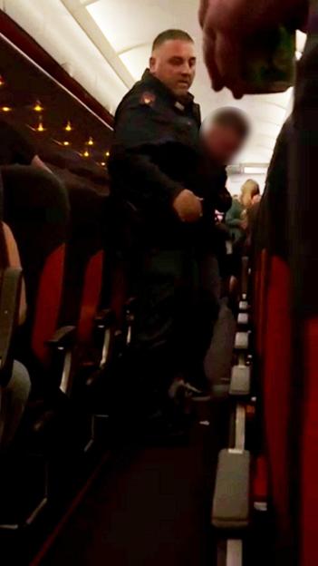 Watch moment ‘disruptive’ passenger clutching vodka is dragged off EasyJet flight to Greece after ’emergency landing’