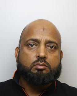 Mugshot of a man with a beard.