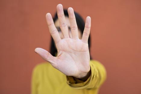 Woman holding up hand in stop gesture.