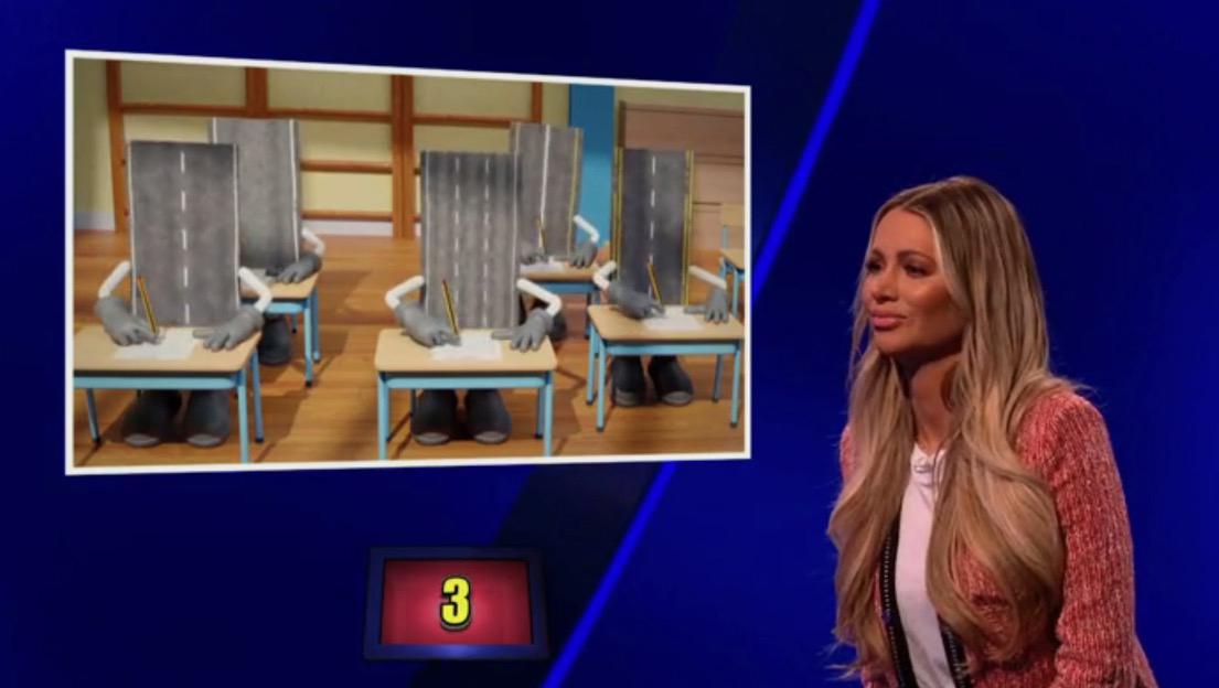 Olivia Attwood looks at an illustration of road segments with arms and legs taking a test.
