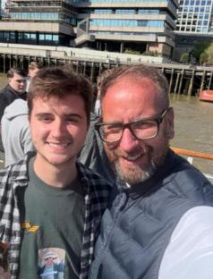 Selfie of two men on a boat, one of whom is an American tourist who accidentally joined a boat party for Southend United football fans.