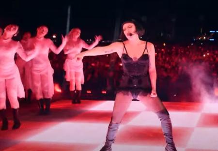 Lady Gaga performing on stage at Coachella with backup dancers.