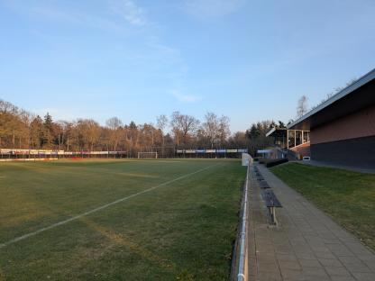 Soccer field with benches and a building in Bergentheim, Netherlands.