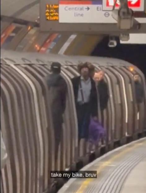 Cyclist Stages Standoff with Train Staff, Ignoring Requests to Move Bike While Frustrated Passengers Look On