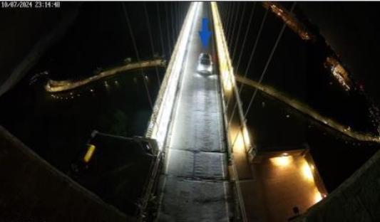 Car driving on Clifton Bridge at night.