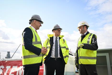 Prime Minister Sir Keir Starmer and two others in hard hats and safety vests.