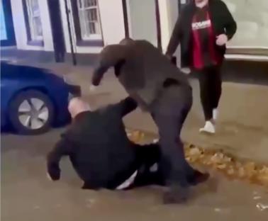 MP Mike Amesbury punching a man on the ground.