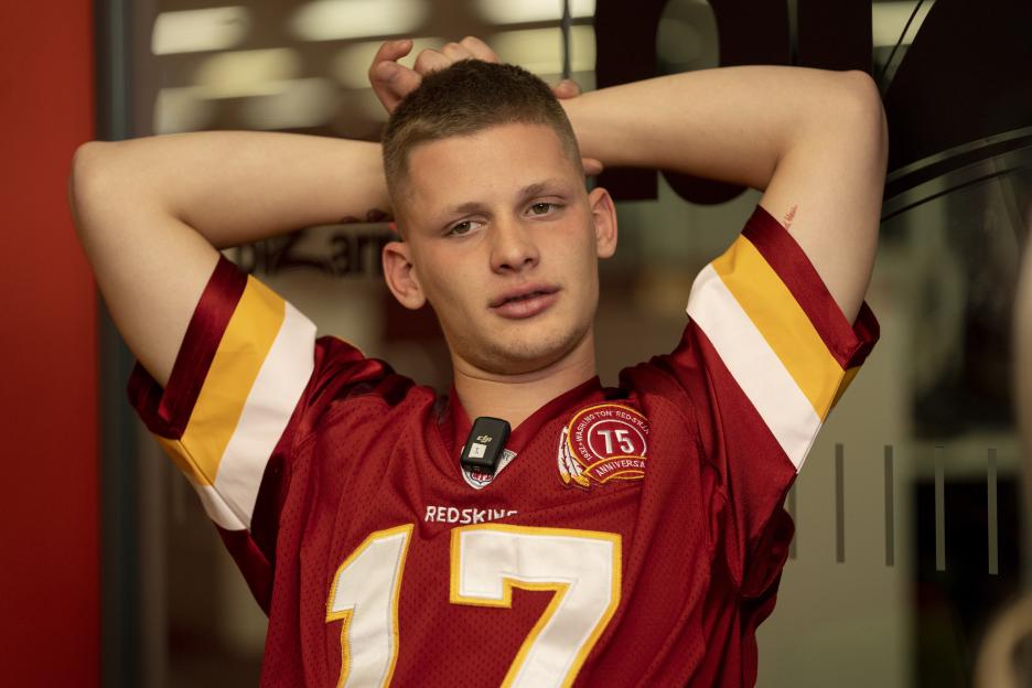 A young man in a Washington Redskins jersey.
