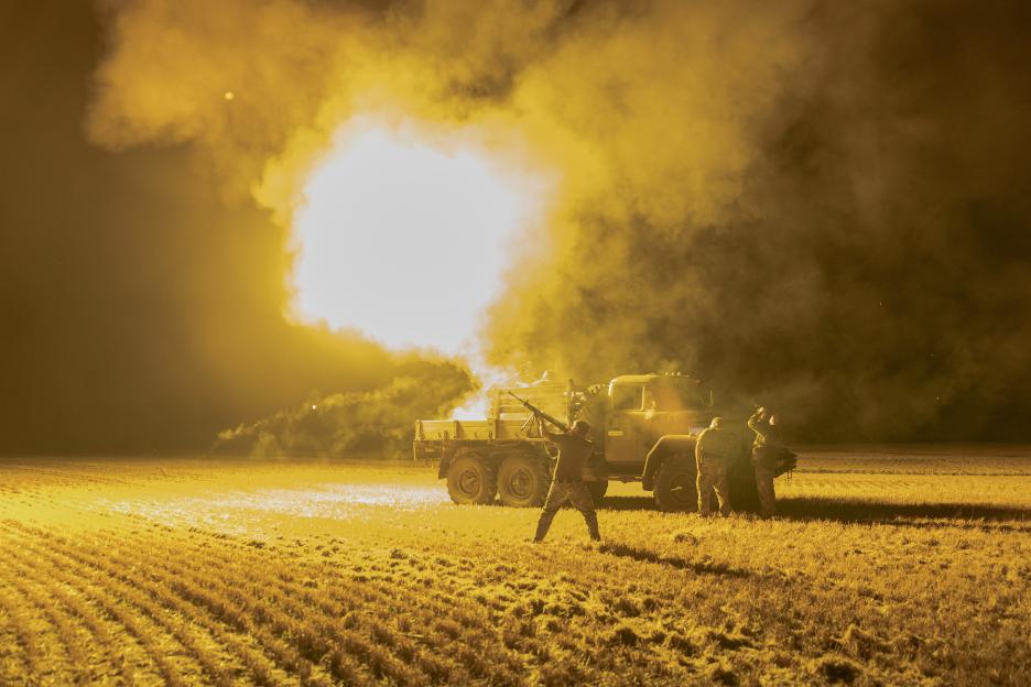 Ukrainian soldiers firing anti-aircraft weapon at night.