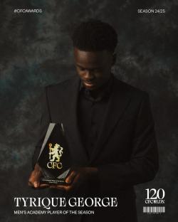 Tyrique George holding his Men's Academy Player of the Season award.