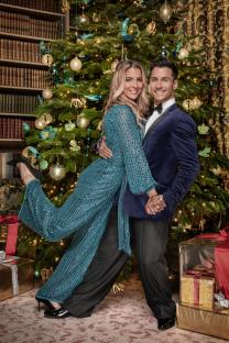 Gemma Atkinson and Gorka Marquez dancing in front of a Christmas tree.