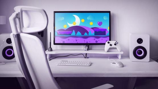 Gaming setup with purple-themed game displayed on computer monitor.