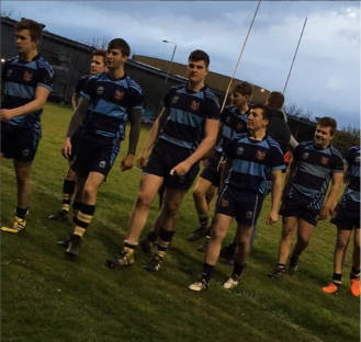 Rugby team walking on a field.