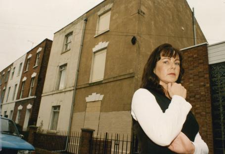 Caroline Owens outside 25 Cromwell Street, the former home of Fred and Rose West.