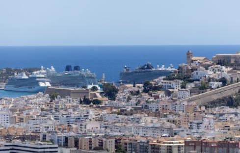 Ibiza town and two cruise ships in port.