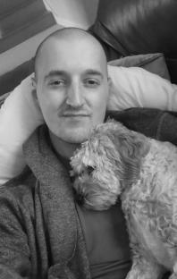 Black and white photo of a man with his dog.