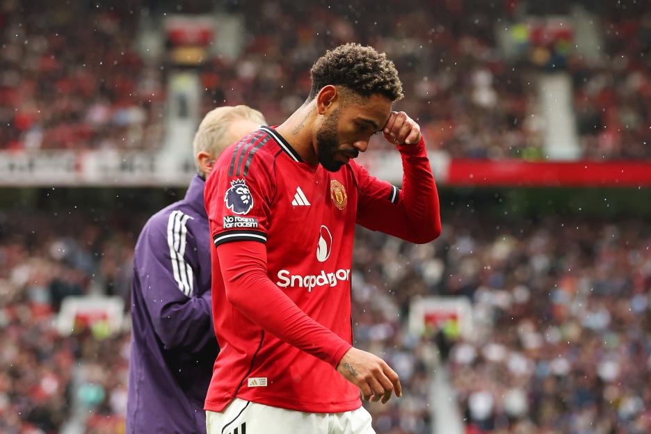 Matheus Cunha of Manchester United leaves the pitch following an injury.