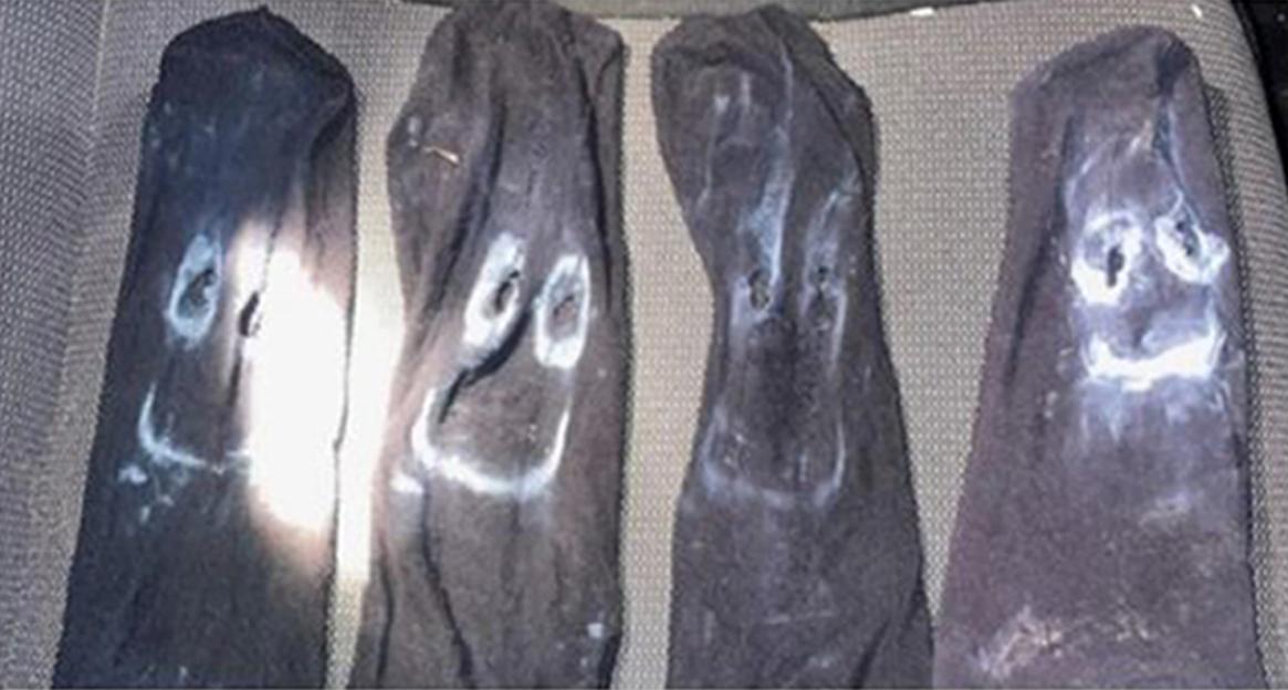 Four socks with painted-on faces.
