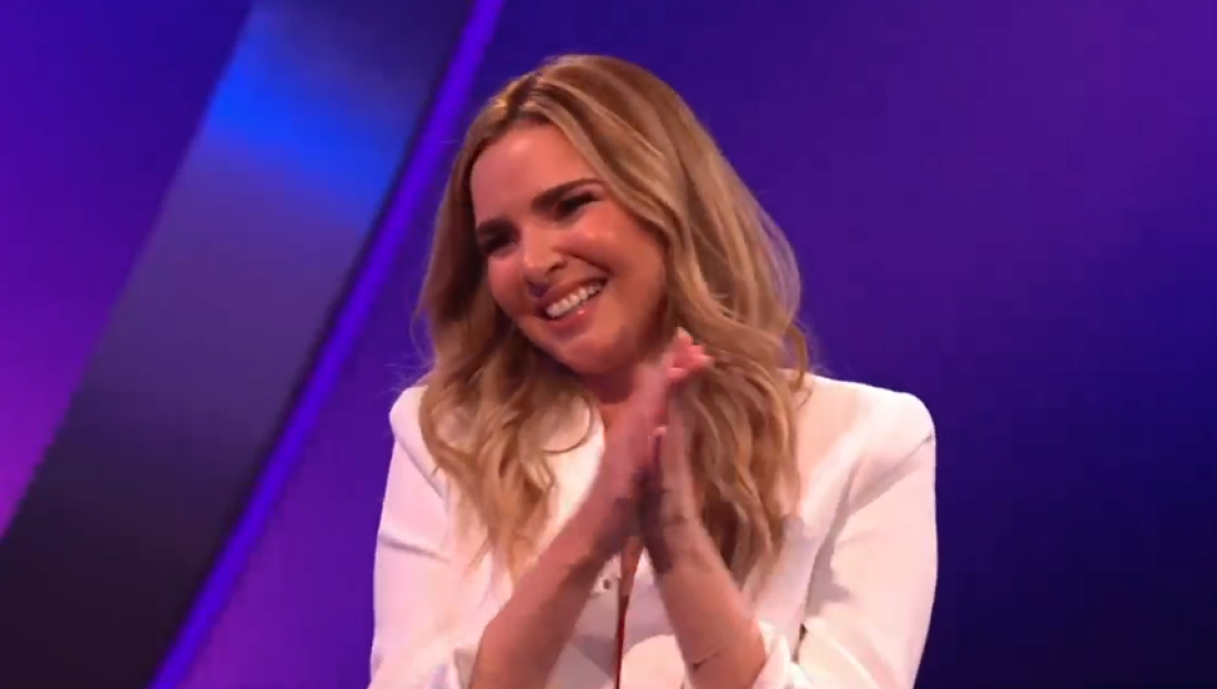 Woman smiling and clapping.