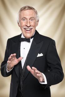 Portrait of Sir Bruce Forsyth in a tuxedo.