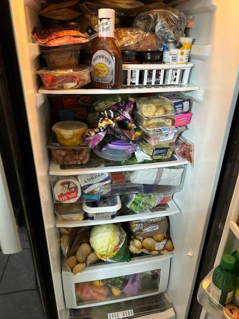 A full fridge with different foods and ingredients.