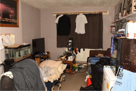 Photo of a messy living room shown to a jury during a cross-examination.